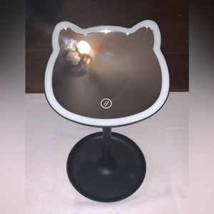 This is a cat shaped makeup mirror.